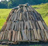 fileadmin/roha/images_galerie/orte_landschaft/Teisendorf/Neukirchen/TEI-NEUK-KOEHL-0009-01-D-roha-Neukirchen-Kohlenmeiler-Brauchtum-Koehler-Holzscheite-Buche-Fichte.png