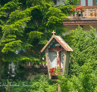 fileadmin/roha/images_galerie/orte_landschaft/Inzell/KKKM-INZ-0003-D-roha-Wegkreuz-Inzell-Balkon-Blumenschmuck.png